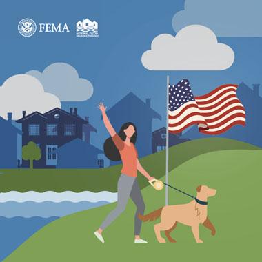 Woman walking her dog past an American flag, next to a lake, with city homes silhouetted in the background