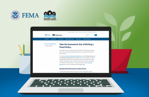 Open laptop on blue table browsing FEMA website.