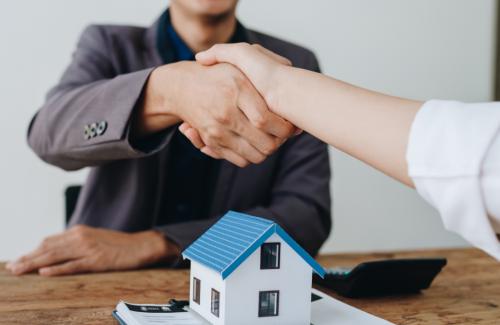 People shaking hands over a home agreement
