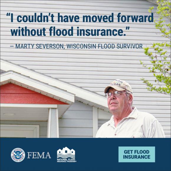 An image of a man standing outside a house