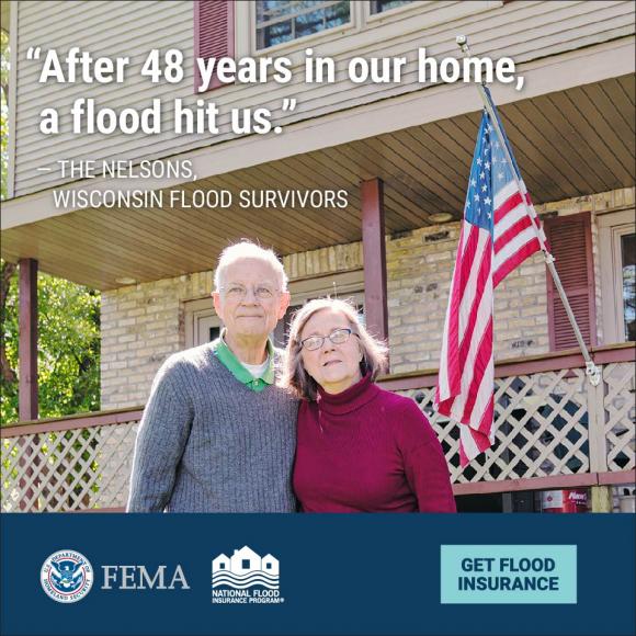 An image of a couple standing outside a house