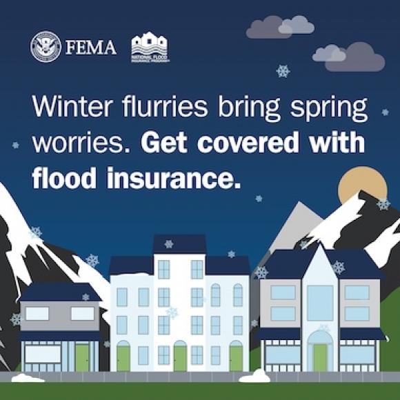 City center during snow storm, with snowy mountains in the background. Text: Winter flurries bring spring worries. Get covered with flood insurance