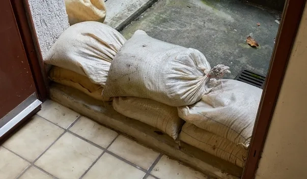Sandbags piled up in front door of house